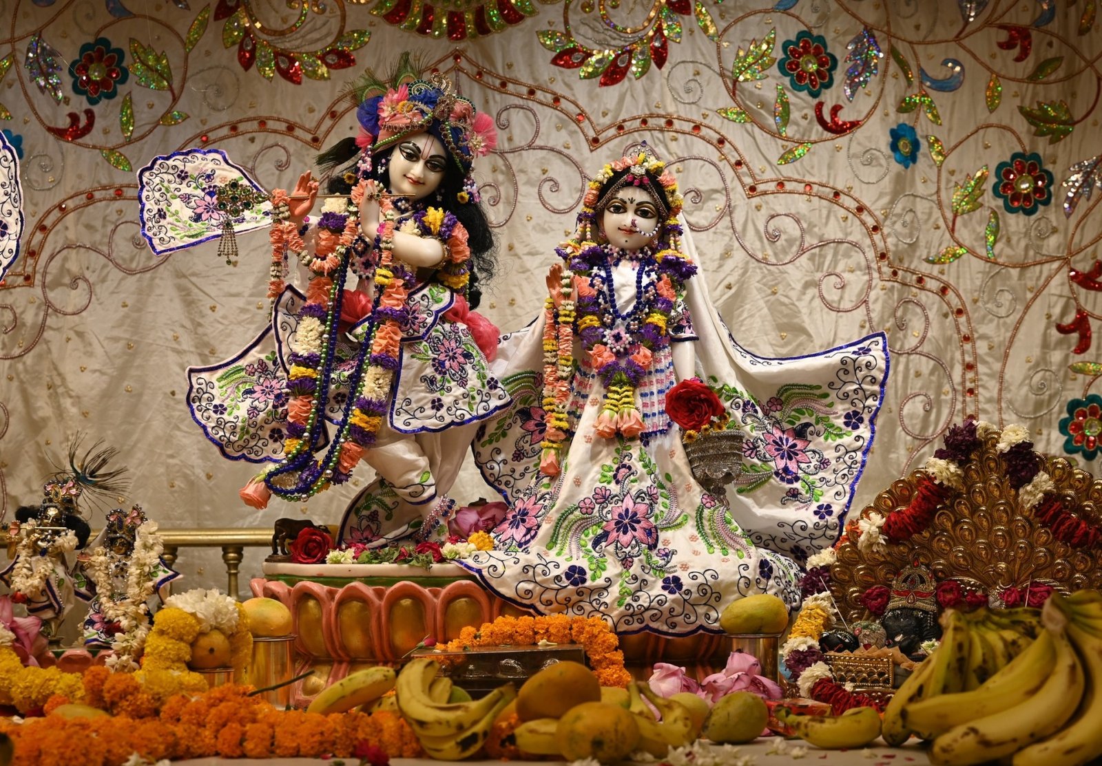 Devotee singing kirtan into a microphone at ISKCON Rewari
