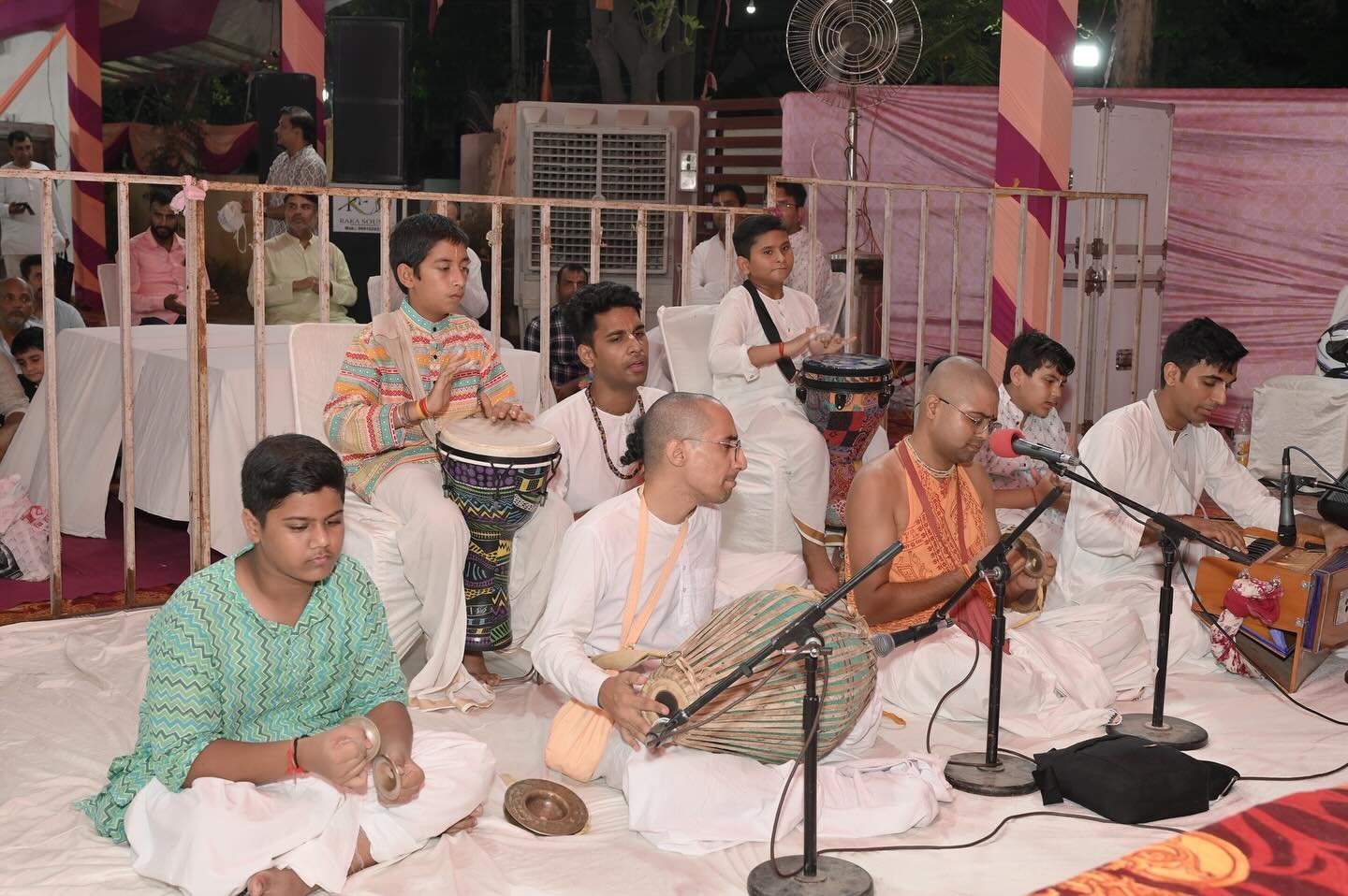 Devotees performing kirtan with instruments at ISKCON Rewari